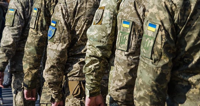 Ukrainian soldiers on military parade. Ukrainian flag on military uniform. Ukraine troops.