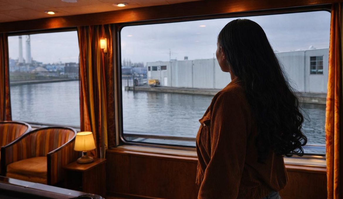 Van Belarus – A woman seeking asylum stands inside a converted boat